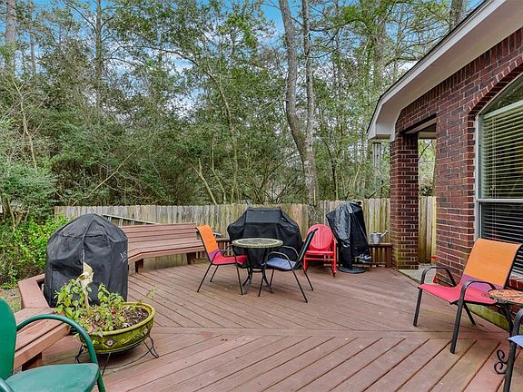 This outdoor space includes a covered porch, large deck for entertaining and enjoying the greenbelt space.