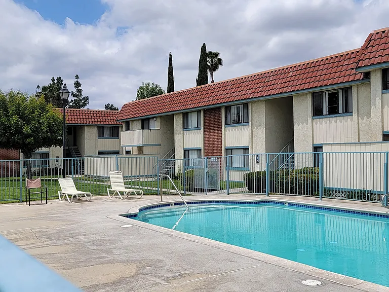 Inviting swimming pool and sun deck at Magnolia Apartments in Riverside, California.