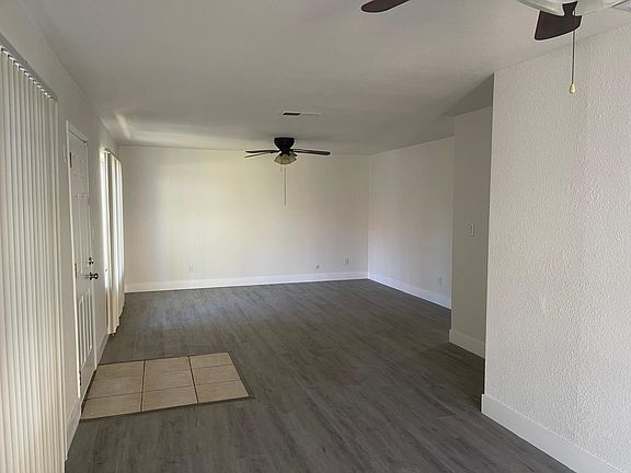 Open floorpan with new wood & tile flooring, freshly painted throughout, including ceilings, new baseboards & ceiling fans throughout