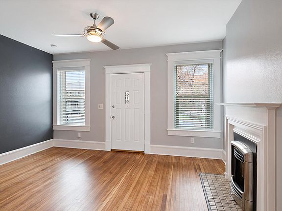 Living Room - refinished hardwood and a fireplace...cozy.