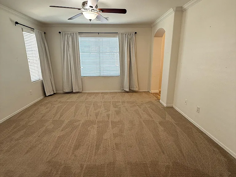 Spacious primary retreat featuring custom designer wall treatments and abundant natural light.