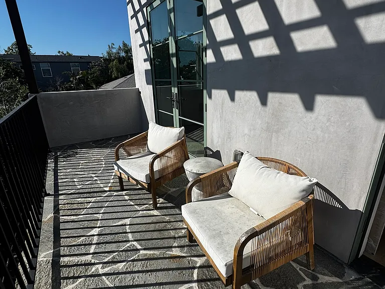 The upstairs balcony can be accessed via the primary bedroom or upstairs office and gets great afternoon sunlight.