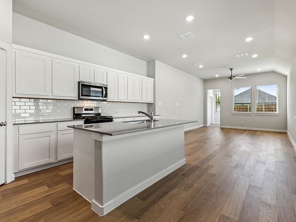Kitchen in the Cedar home plan by Trophy Signature Homes - REPRESENTATIVE PHOTO