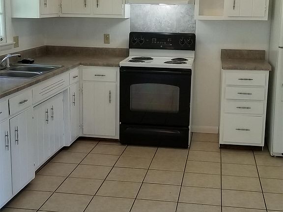 Large Kitchen with Tile floors, range and fridge included.