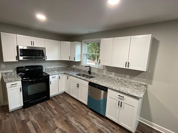 New kitchen new microwave new stainless dishwasher and stove, granite countertops, farmhouse sink