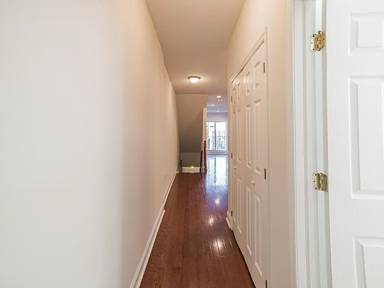 Second floor hallway descending to first floor exit.