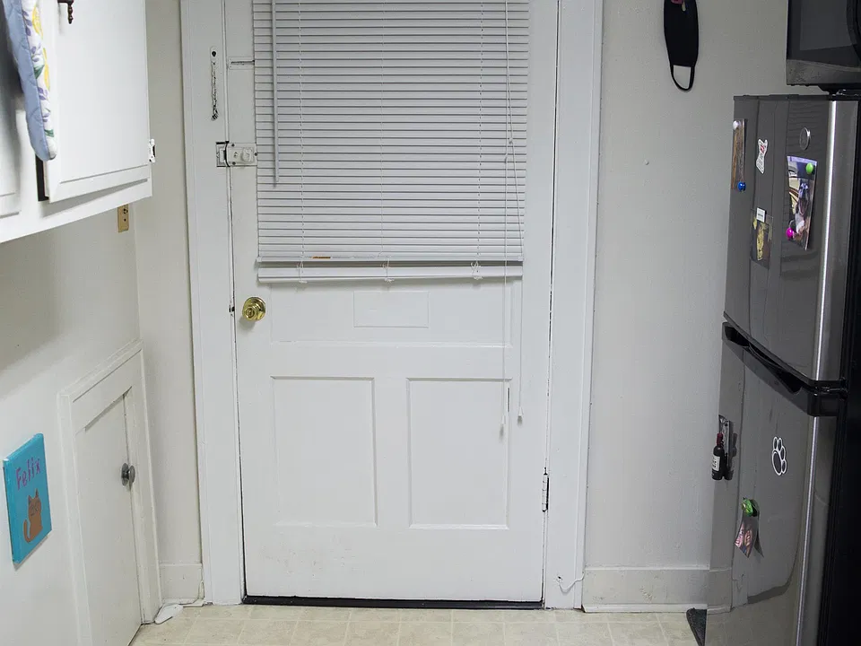 Back exit to an enclosed porch.