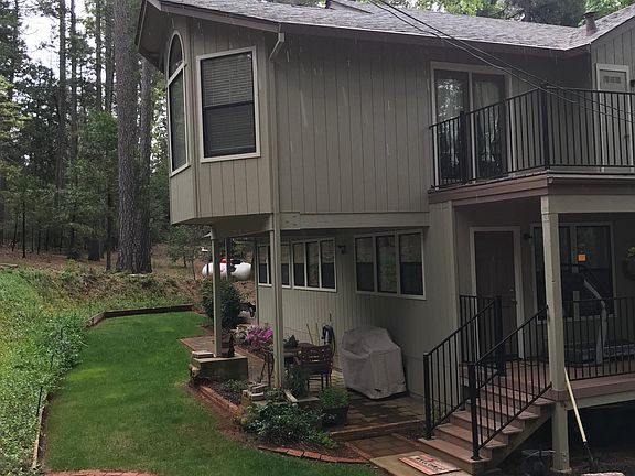 Back Patio and lawn, side covered deck & 1 of 2 upper balconies