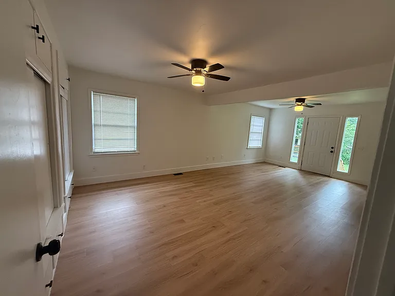 Spacious primary bedroom featuring a private en-suite bathroom, direct access to the backyard, and generous closet space for all your storage needs.