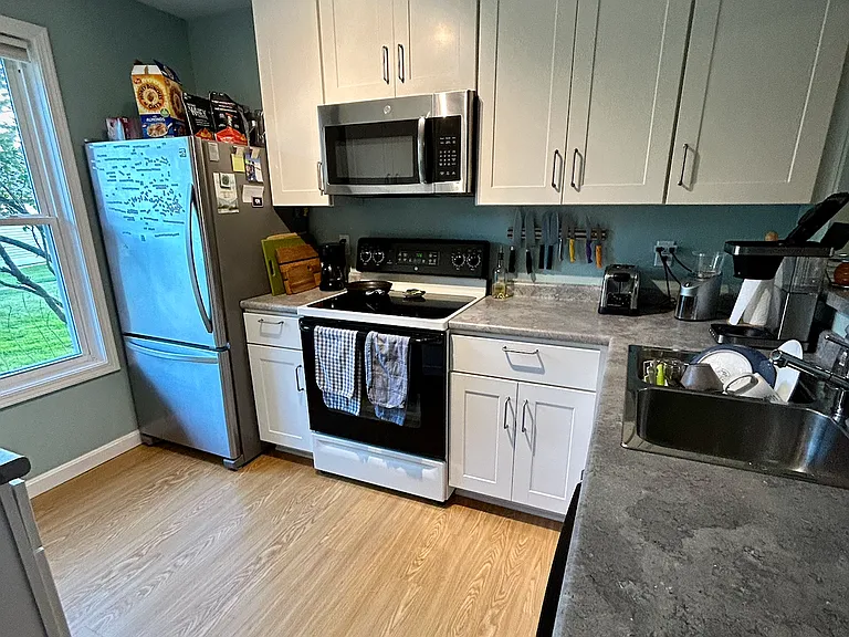 Fully stocked kitchen including stainless steel and cast iron pans