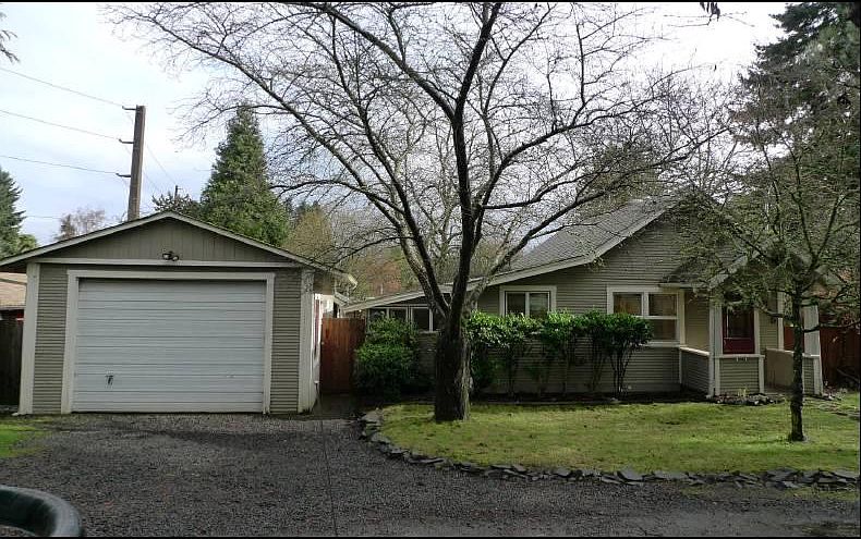 Front yard with semi-circle driveway, garage and breezeway e