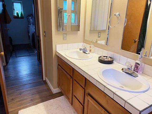 Master/upstairs bathroom (entrance to main upstairs hall -see in pic- as well as entrance to master through adjacent door). Laundry room seen in background. Walk out to the left to the bedroom. Walk out to the right to the main living/dining/kitchen a