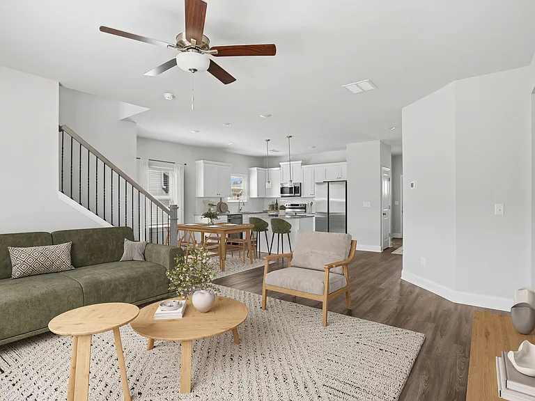 Living room with open view to kitchen and hallway.