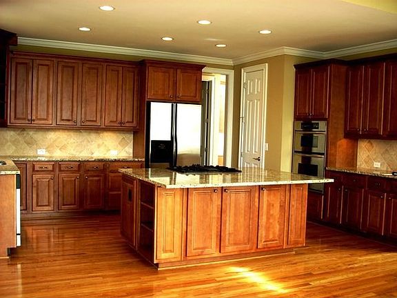Gourmet Kitchen with Granite Countertops, Center Island, and Tiled Backsplash.