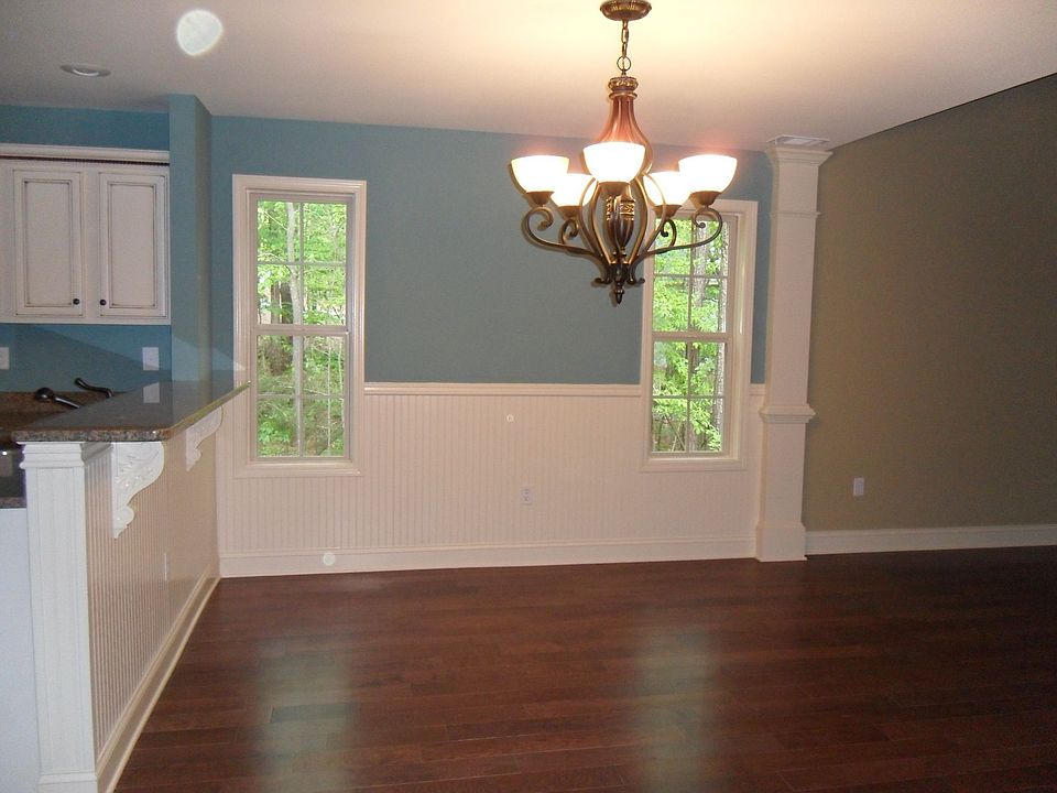 Formal dining room with wainscoating and hardwood floors
