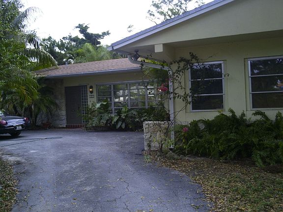 large circle drive with garage and side lot parking