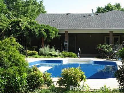 View of back of home/pool : Pool area and back porch.