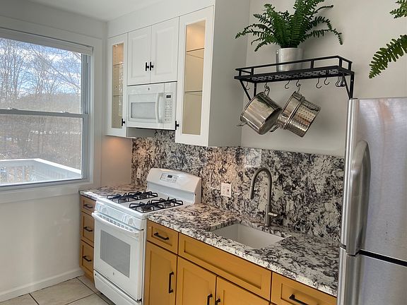 Kitchen with granite counters and back splash, glass front cabinets!