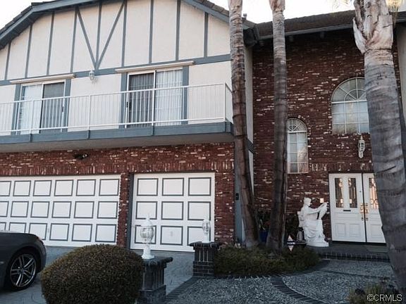 Three-car attached Garage has storage shelves