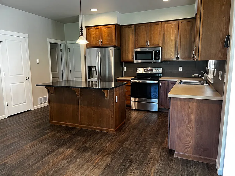 Open concept kitchen and dining with updated appliances and pantry closet.