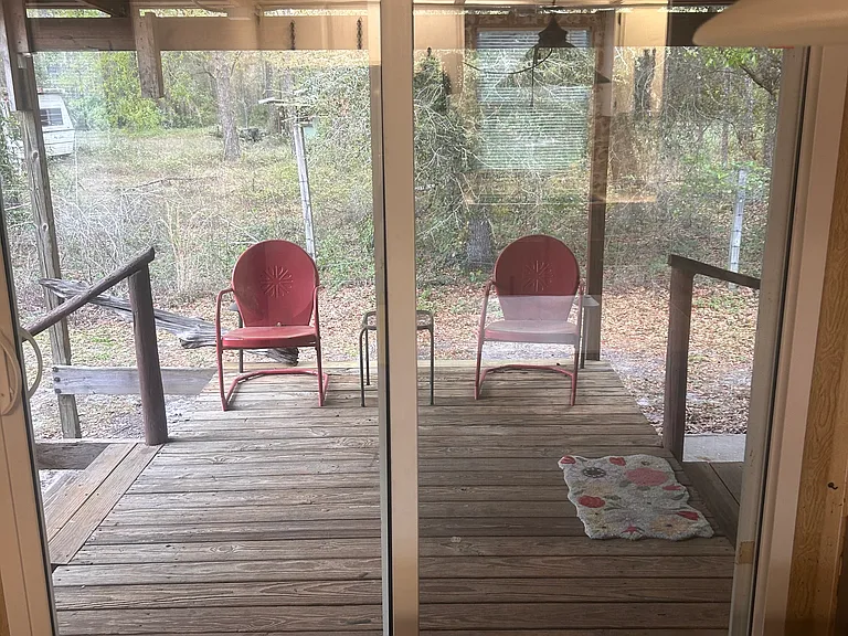 Back deck with two chairs from kitchen