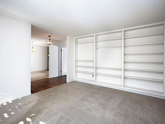 A wall of built-in bookcases in the living room.