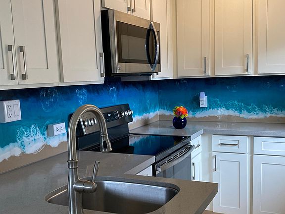 Brand new ocean themed kitchen with modern appliances.