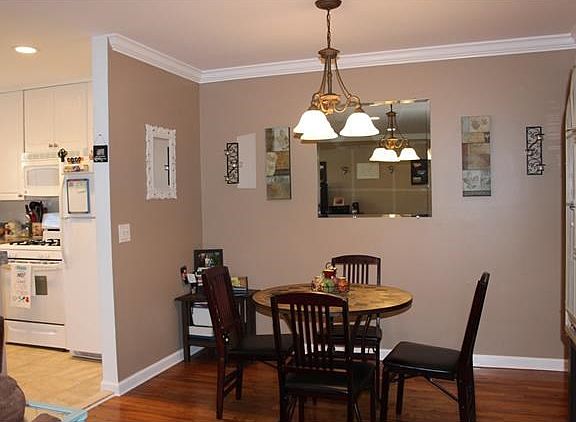 Dining area with crown molding and hardwood floors.