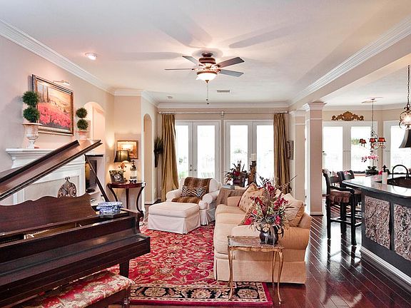 This view of the living area was taken from the foyer offering sweeping views of the back yard and p