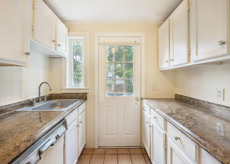 Galley kitchen with fridge, dishwasher, and sink