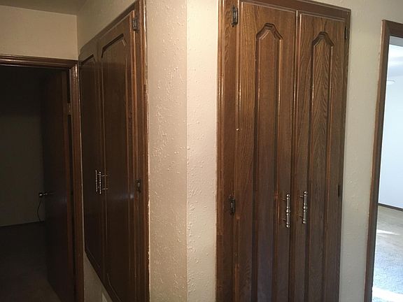 view of linen closet from hallway going to front room.