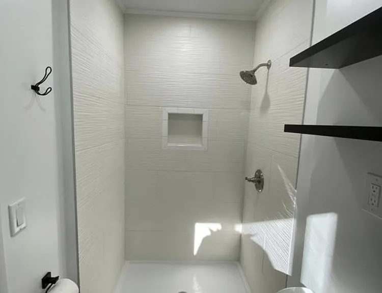 Gorgeous tiled shower and open shelving