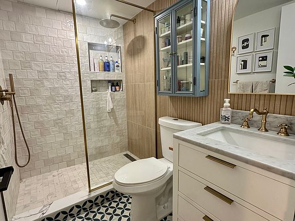 Updated Bathroom with walk-in shower located in hallway, adjacent to bedroom #1. Renovated in 2024.