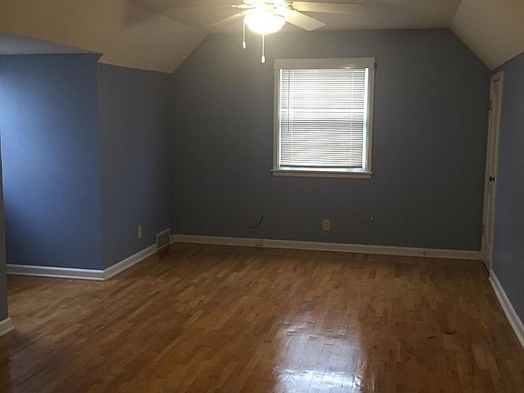Upstairs bedroom (approx. 19'x11') with walk-in storage behind wall.
