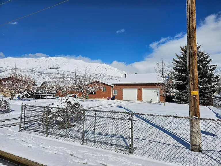 Front of house showing fenced in yard