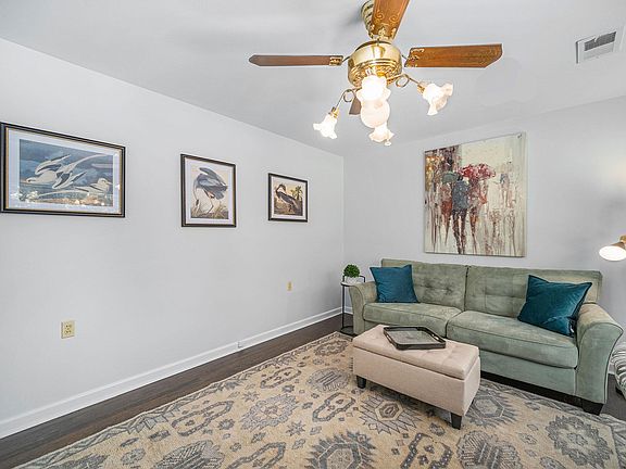 First living area with Smart TV and workspace with desk