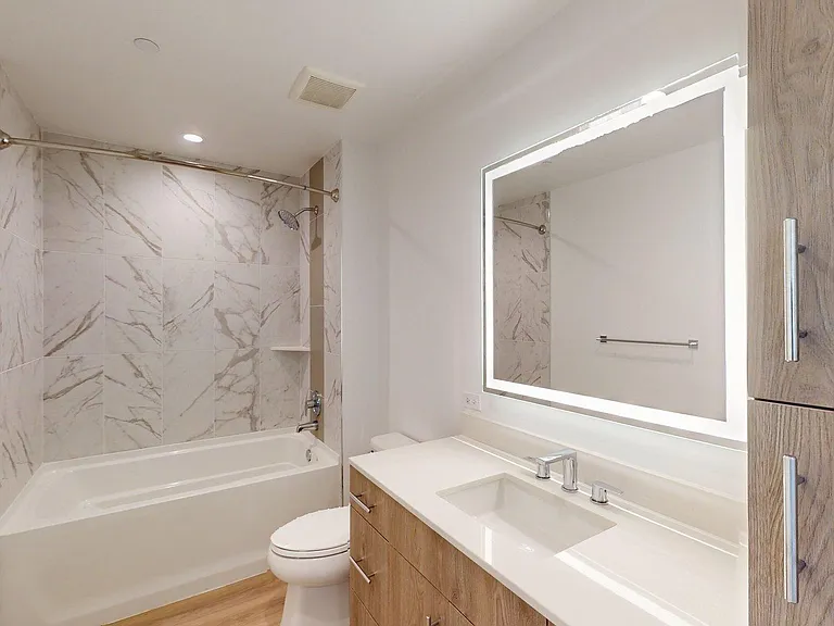 Apartment Bathroom with large soaking tub,Sink , LED vanity mirror and wood-style flooring