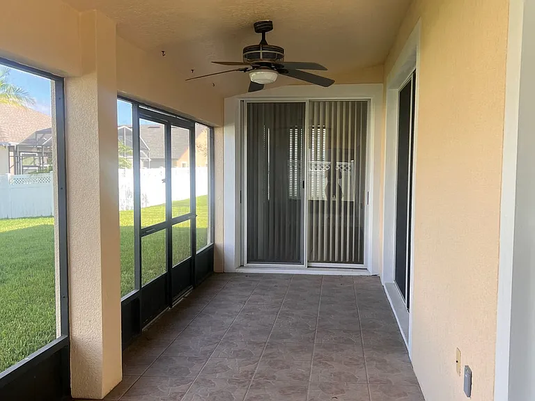 48 - Screened back patio with ceiling fan, perfect for outdoor relaxing.