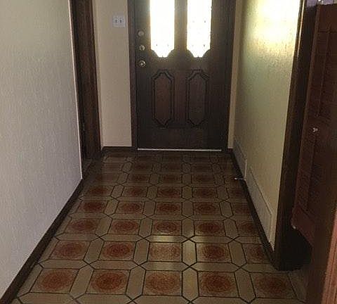 Front door entry hall. Gorgeous original tile. Dry bar with cabinets off entry hall.