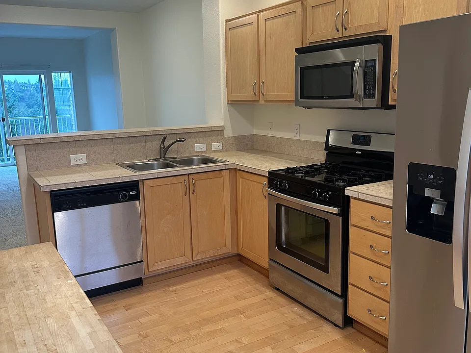 Stainless steel appliances in large kitchen