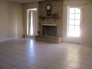 Rear Family room with 16" tile and fire place