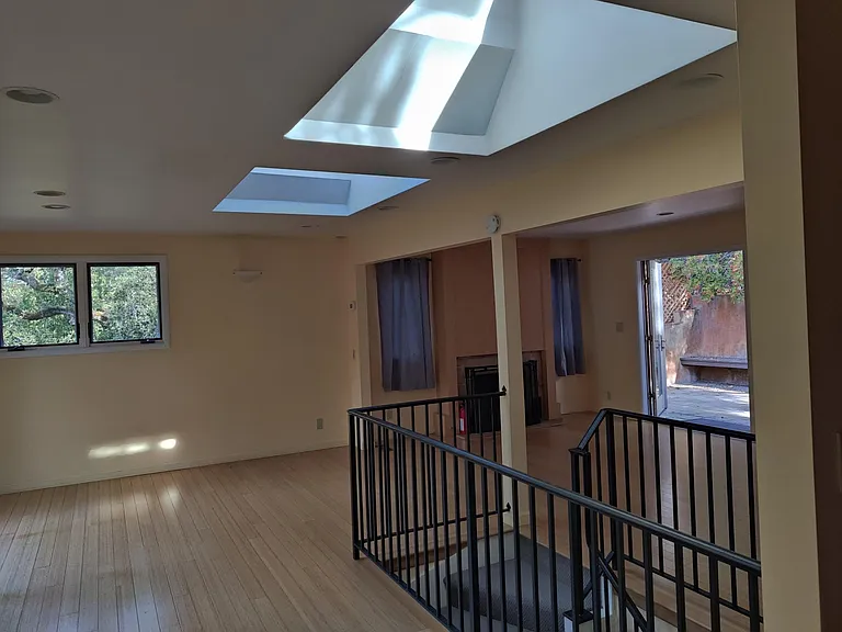 Upper floor living area - velux skylights have automatic openers and shades