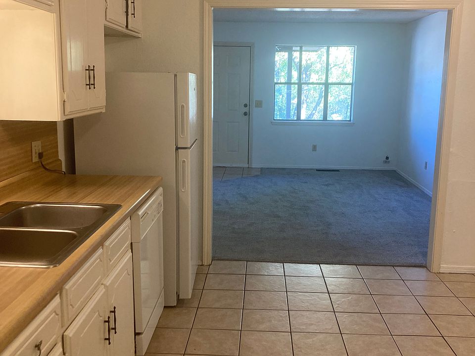 Stainless steel double sink, plenty of cabinet storage, electric range with hood vent, and eat in area.