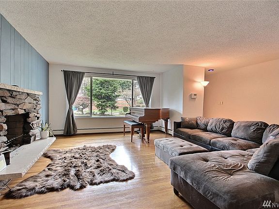 Spacious living room with cozy wood burning fireplace.