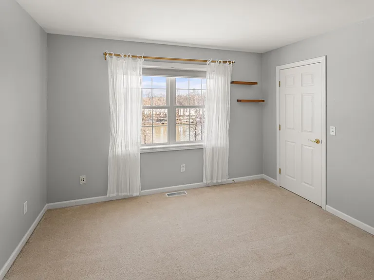 Bedroom with closet overlooking the Winooski River.