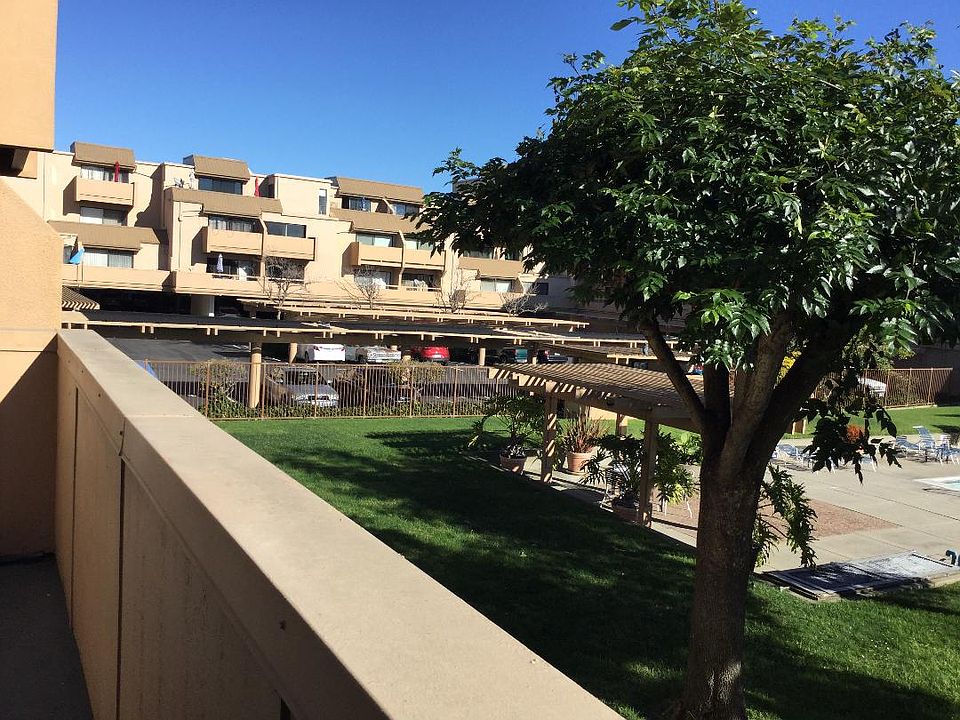 Picture of the building. The condo deck overlooks the pool and hot tub area