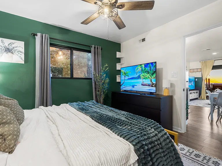 Relax in a cozy bedroom with a TV for comfort and entertainment.