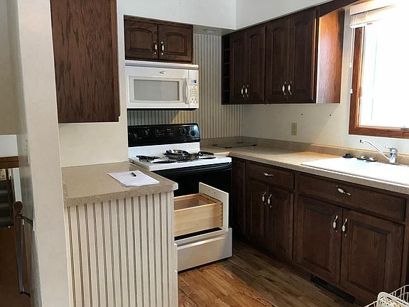 Kitchen left side, bread drawer open. Sink/GD/DW, water filter.