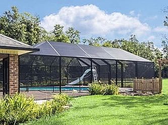 Screen enclosure around pool
