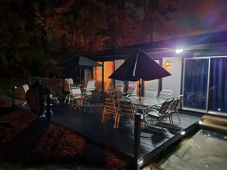 Huge patio deck with 18-20 person seating available with barrel charcoal grill, large hibachi grill and fish fryer equipment available for use. Bright solar lighting for night entertainment!